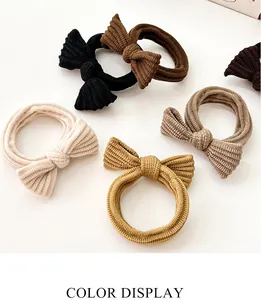 Detail of high-elasticity bow hair ties in various earthy tones and ribbed fabric