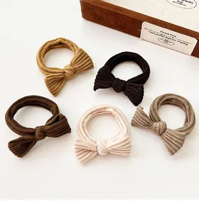 Detailed macro view of 5-piece corduroy bow scrunchies in minimalist earthy tones