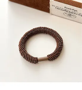 Close-up of brown elastic braided hair tie with durable texture and seamless joint