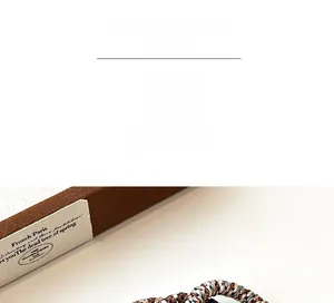 Macro shot of durable braided elastic hair tie in coffee and beige tones