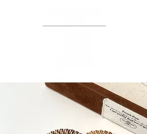 Detailed close-up of handmade milk coffee braided hair tie with elegant golden silk texture