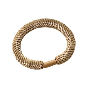 Thick high-elasticity braided hair tie in brown with subtle gold metallic shimmer