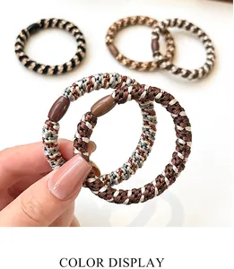 Close-up of elastic woven hair ties with plastic beads in various milk tea colors