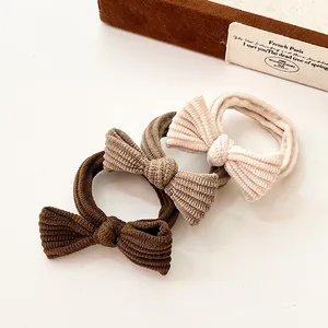 Three-piece set of textured bow hair scrunchies in coffee, tan, and cream tones