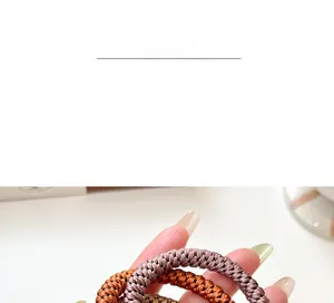 Close-up of thick braided elastic hair ties in brown and coffee colors for ponytails