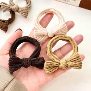 Bow hair scrunchies in cream and brown ribbed knit fabric for elegant daily ponytails