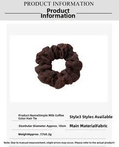 Detailed view of coffee-colored pleated fabric scrunchie with 10cm outer diameter
