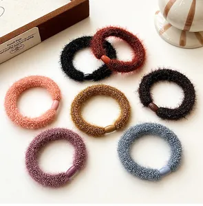 Close-up of 7 multi-colored elastic plush hair ties with soft texture and resin buckles