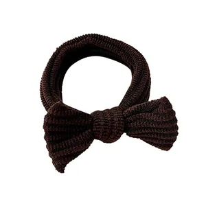 Elastic coffee brown bow scrunchie with ribbed knit texture for minimalist hair styling