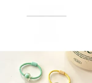 Detail of candy-colored beaded elastic hair bands for girls with decorative clear round beads