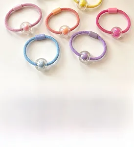 Close-up of candy color beaded elastic hair ties set in pink blue and yellow