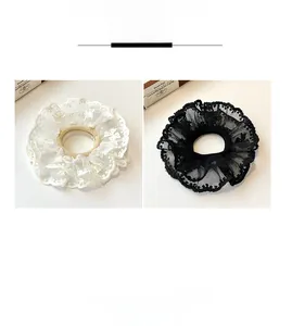 Detailed close-up of double-layer lace scrunchies in elegant black and white mesh