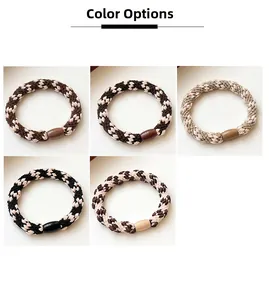 Detail view of woven elastic hair ties in five assorted colors with smooth resin buckles