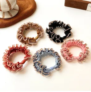 Detail of five-color ruffled elastic hair ties with shimmering gold metallic edge weaving
