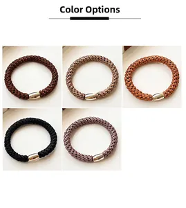 Close-up of five elastic ponytail holders in brown tones with metallic buckles