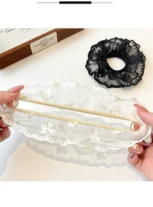 Detail showing the stretch and high elasticity of double-layered lace hair scrunchies