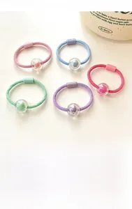 Detailed view of five pastel candy-colored high-elastic hair ties with acrylic bead pendants