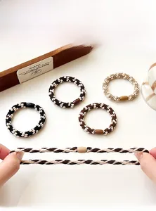 Detail display of high-elasticity braided hair ties showing four earthy tone colors and stretch