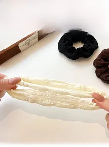 Detailed close-up showing high elasticity and fabric texture of pleated hair scrunchies
