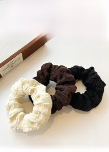 Three-piece textured puff scrunchie set in cream, coffee, and black fabric