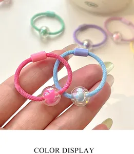 Detailed view of candy-colored elastic hair ties with colorful resin ball pendants
