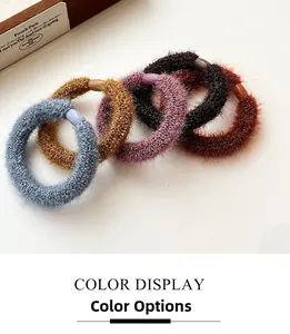 Close-up of five plush elastic hair ties in muted colors with oval decorative buckles