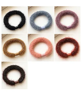 Detailed macro view of seven colorful plush hair ties with soft texture and matching clips