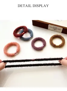 Close-up of thick plush elastic hair ties showing high stretch and durable texture