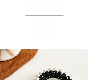 Close-up of black and white polka dot scrunchie with delicate white ruffled lace edges