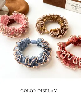 Detailed view of elastic hair scrunchies with lace edges in four various colors