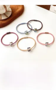 Close-up of high-elasticity crystal hair ties in five assorted Morandi colors on white background