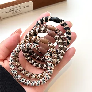 Five pack of thick elastic woven hair ties with resin buckles in neutral coffee tones