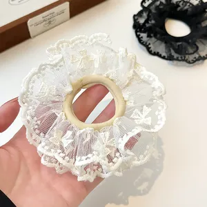 Elegant double-layer lace scrunchies in white and black with delicate embroidery details