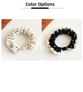 Polka dot hair scrunchies with delicate lace edges in black and white color options