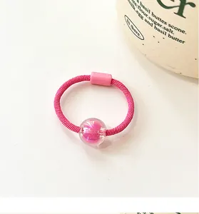 Pink high-elastic hair tie with a clear sphere charm featuring a sweet pink bead inside