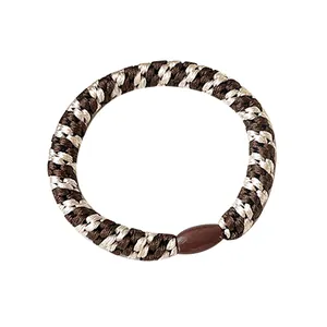 Elastic braided hair tie in brown and beige colors with a durable plastic clasp