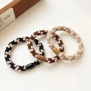Three-piece set of woven elastic hair ties in checkered patterns with plastic buckles