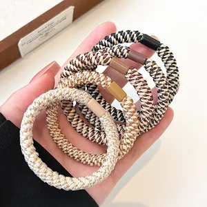 Five-piece set of woven elastic hair ties in neutral tones like coffee and cream