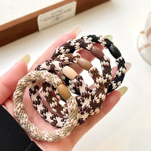 5-piece set of woven elastic hair ties with decorative beads in neutral earth tones