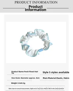 Detail showing the 8cm diameter and floral fabric texture of this elastic hair scrunchie