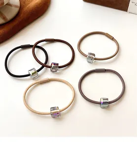 Detailed view of five high-elasticity hair ties with iridescent square crystal beads