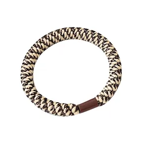 Cream and coffee woven elastic hair tie with durable brown clasp on a white background