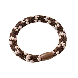 Braided high elasticity hair tie in brown and beige houndstooth pattern weave