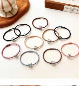 Macro detail of high-elasticity hair ties with colorful iridescent cube bead ornaments