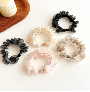 Close-up of five organza scrunchies in Morandi colors with soft wavy pleated texture