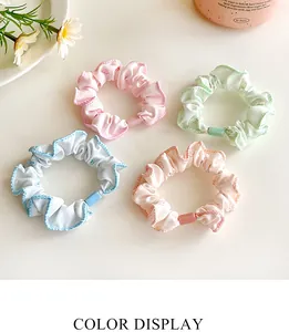 Detail view of four floral scrunchies in pastel colors with wavy edges and flower prints