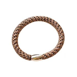 High-elasticity braided hair tie in coffee brown with a sleek gold metallic clasp detail