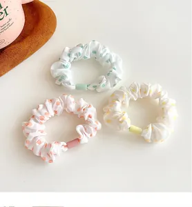 Three-piece set of polka dot hair scrunchies in mint, coral, and lemon colors