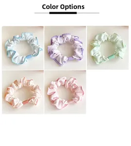 Detail view of five macaron colors elastic hair scrunchies with contrast wave stitching
