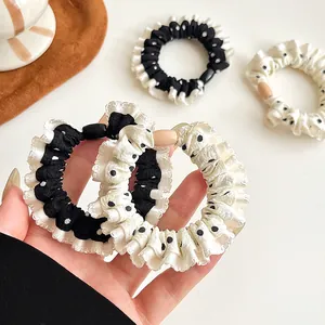 Elegant polka dot ruffle hair scrunchies in black and cream colors with high elasticity